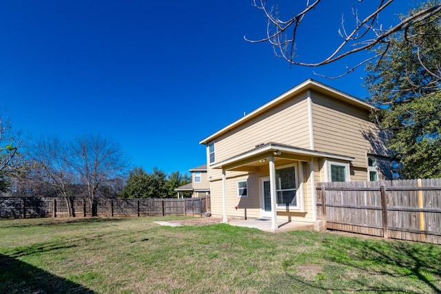 rear view of house featuring a patio and a lawn