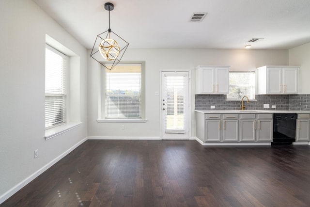 kitchen featuring decorative backsplash, white cabinets, sink, pendant lighting, and dishwasher