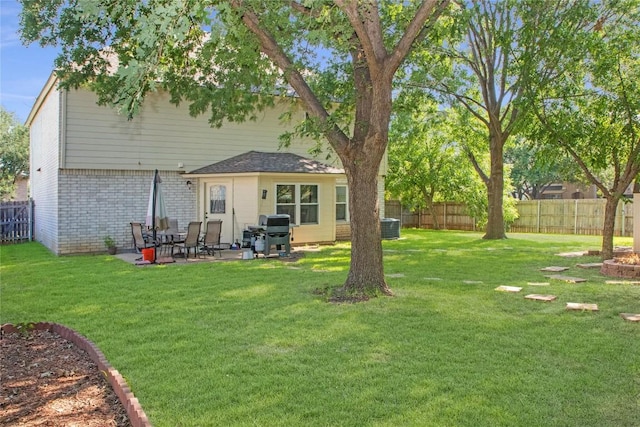 back of house featuring a yard and central AC unit