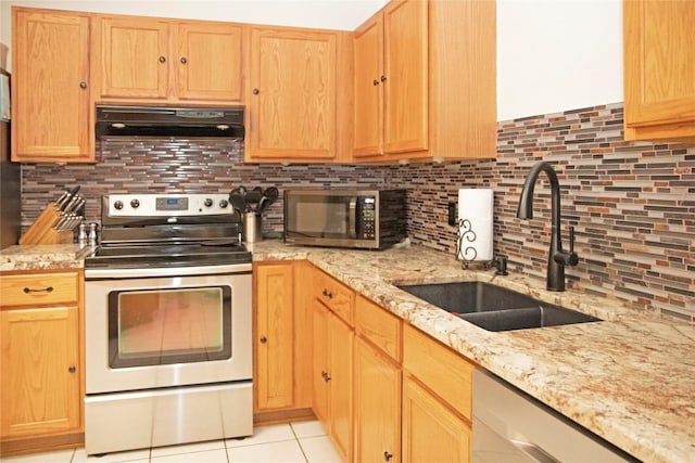 kitchen featuring sink, stainless steel appliances, tasteful backsplash, range hood, and light tile patterned floors