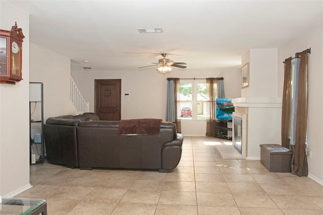 living room featuring ceiling fan and light tile patterned flooring