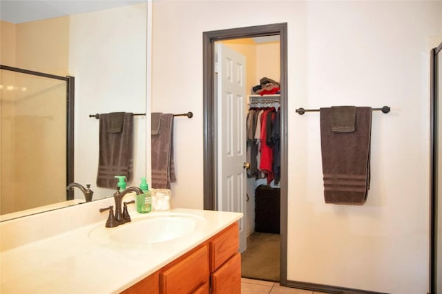 bathroom with vanity, tile patterned floors, and an enclosed shower