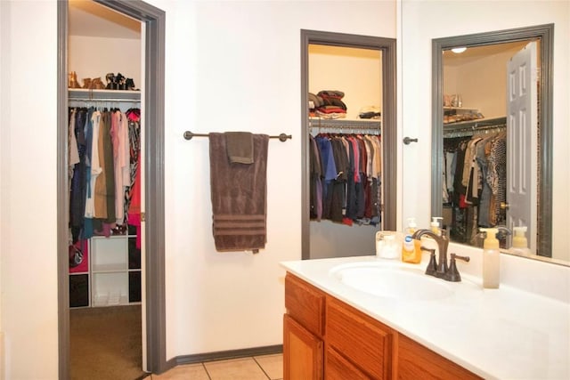 bathroom with tile patterned flooring and vanity