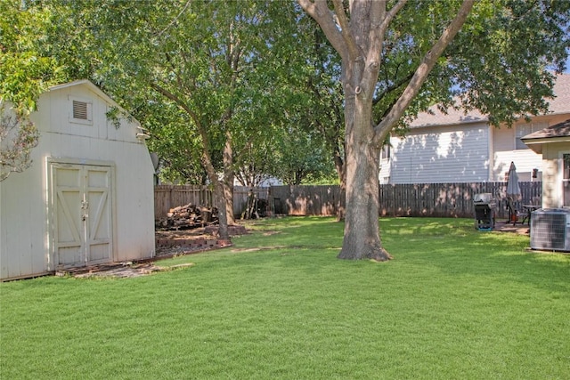 view of yard with central AC unit and a storage unit