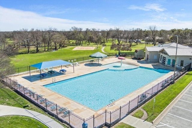 view of pool featuring a lawn and a patio area