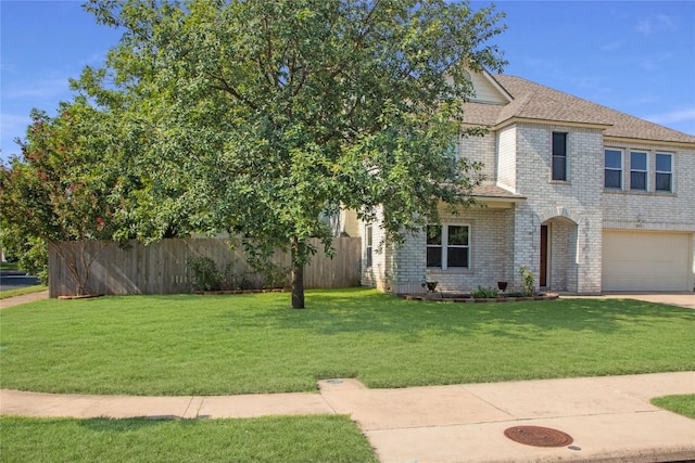 view of front facade with a garage and a front lawn