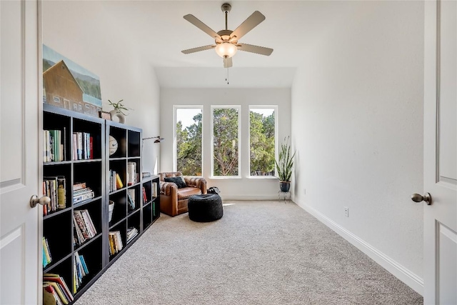 sitting room with a ceiling fan, carpet flooring, and baseboards