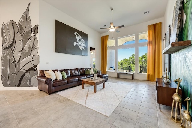 living area with ceiling fan, visible vents, and light tile patterned flooring