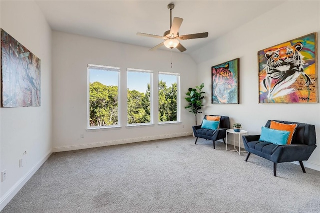 living area featuring ceiling fan, carpet, and baseboards