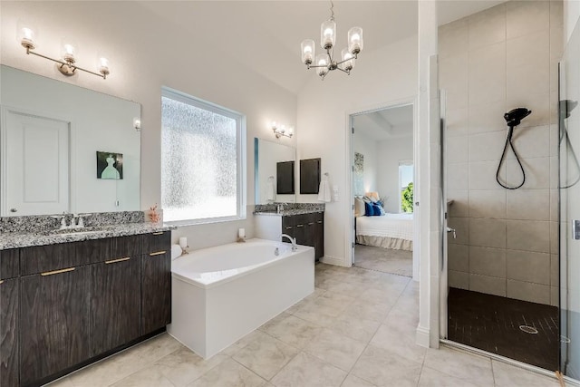 full bathroom with a wealth of natural light, two vanities, and connected bathroom