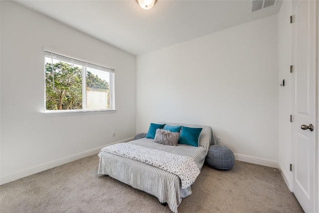 carpeted bedroom featuring visible vents and baseboards