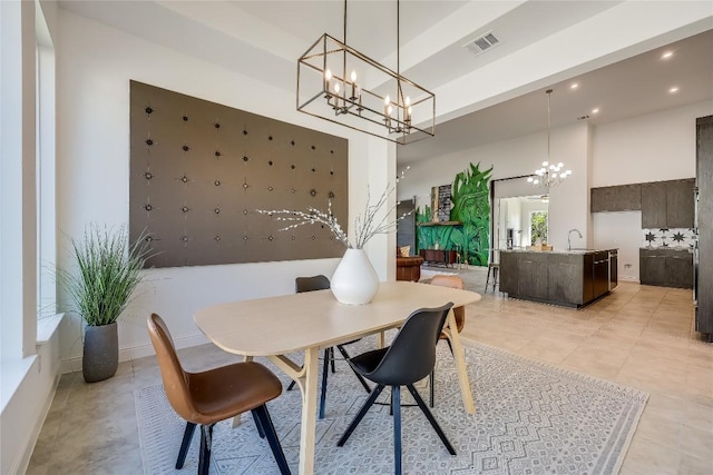 dining area with light tile patterned floors, visible vents, an inviting chandelier, a high ceiling, and recessed lighting