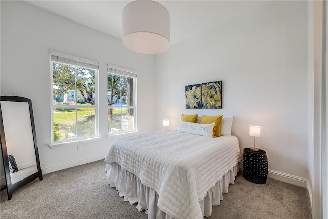 carpeted bedroom featuring baseboards