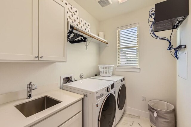 5315 La Crosse Ave Unit 24, Austin, TX 78739 - laundry area with cabinet space, light marble finish flooring, and separate washer and dryer