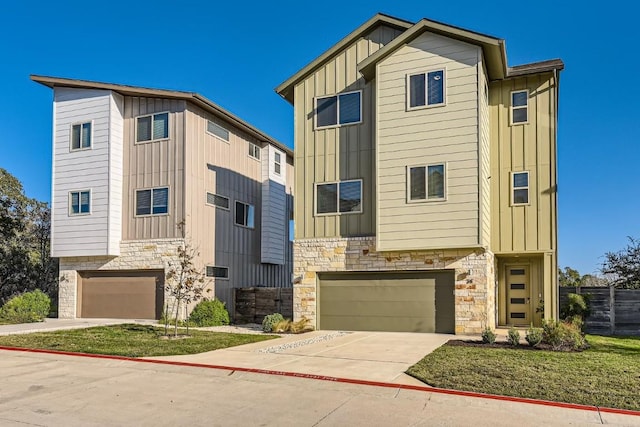 5315 La Crosse Ave Unit 24, Austin, TX 78739 - view of front of house with stone siding, board and batten siding, an attached garage, and concrete driveway