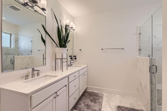 bathroom featuring a shower with door and vanity