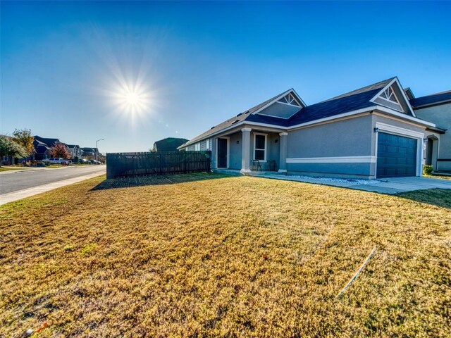 ranch-style house with a garage and a front lawn