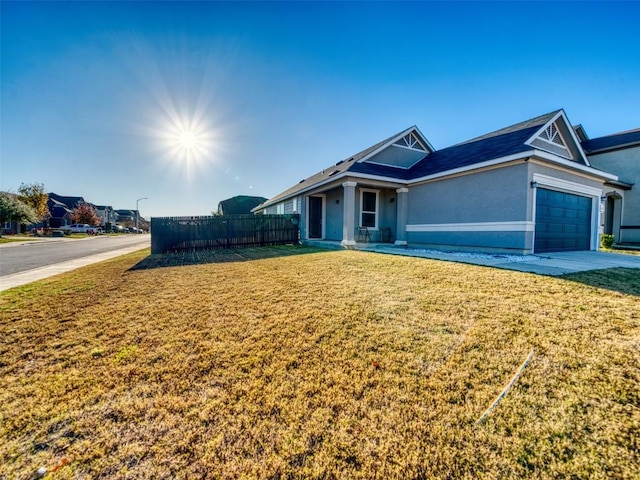 ranch-style house with stucco siding, driveway, a front lawn, a garage, and fence