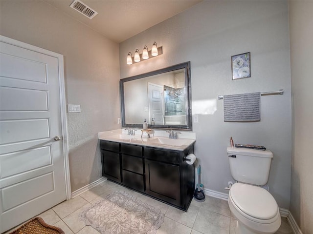 bathroom with double vanity, tile patterned floors, toilet, visible vents, and a sink
