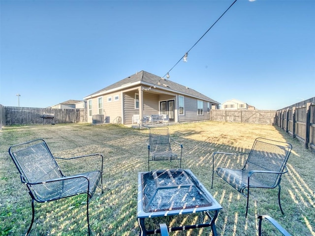 view of yard featuring a garden and a fenced backyard