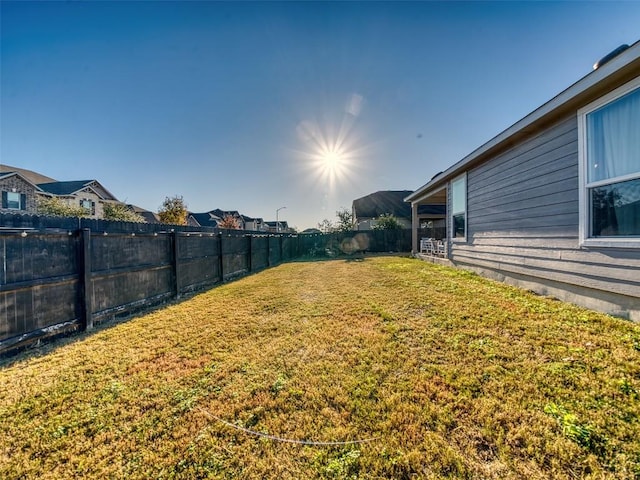 view of yard with a fenced backyard
