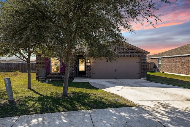 view of front facade featuring a garage and a yard