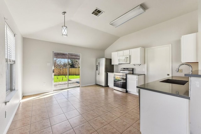 kitchen with stainless steel appliances, sink, light tile patterned floors, white cabinetry, and hanging light fixtures