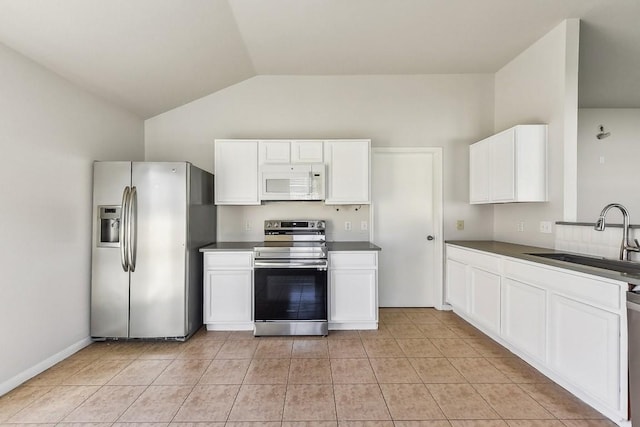 kitchen featuring white cabinetry, sink, lofted ceiling, and appliances with stainless steel finishes