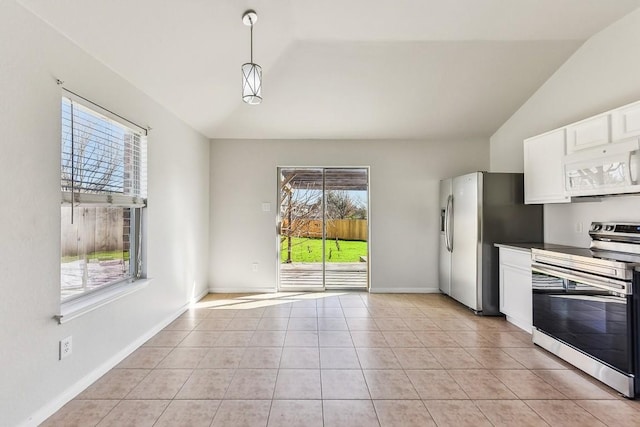 kitchen featuring stainless steel appliances, light tile patterned floors, decorative light fixtures, white cabinetry, and lofted ceiling