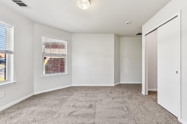 carpeted spare room with a wealth of natural light