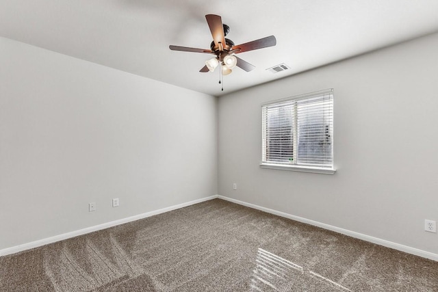 carpeted spare room featuring ceiling fan