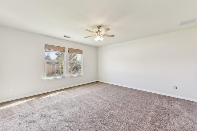 carpeted empty room featuring ceiling fan