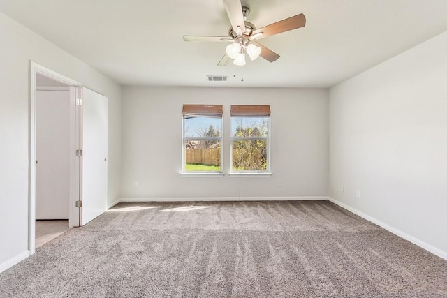 spare room featuring carpet floors and ceiling fan