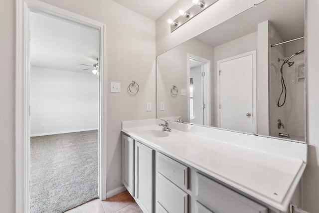 bathroom featuring tile patterned floors, ceiling fan, washtub / shower combination, and vanity