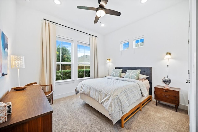 bedroom featuring ceiling fan and light colored carpet