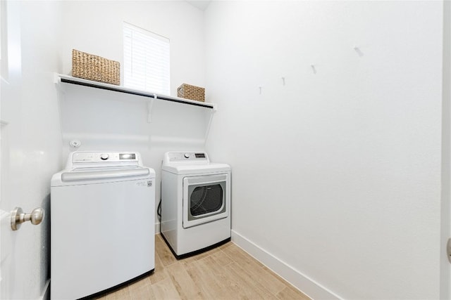 washroom featuring independent washer and dryer and light wood-type flooring