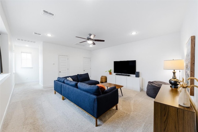 carpeted living room featuring ceiling fan