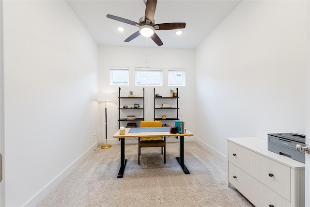 carpeted office space with ceiling fan