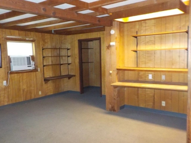 basement with wooden walls, cooling unit, and dark colored carpet