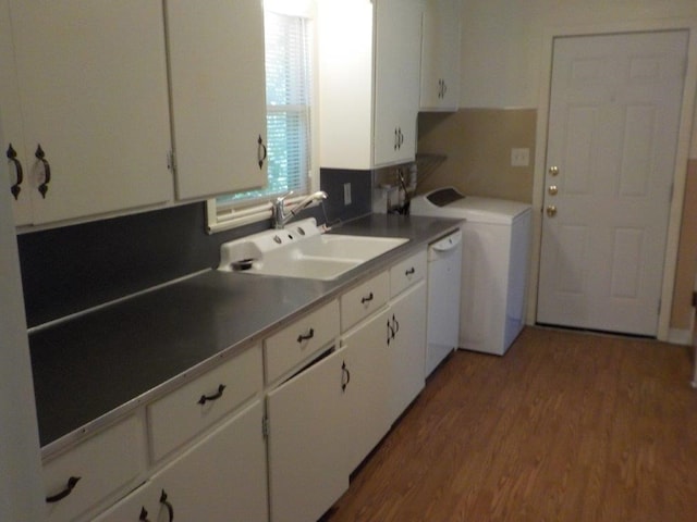 kitchen featuring sink, white cabinets, white dishwasher, and hardwood / wood-style flooring