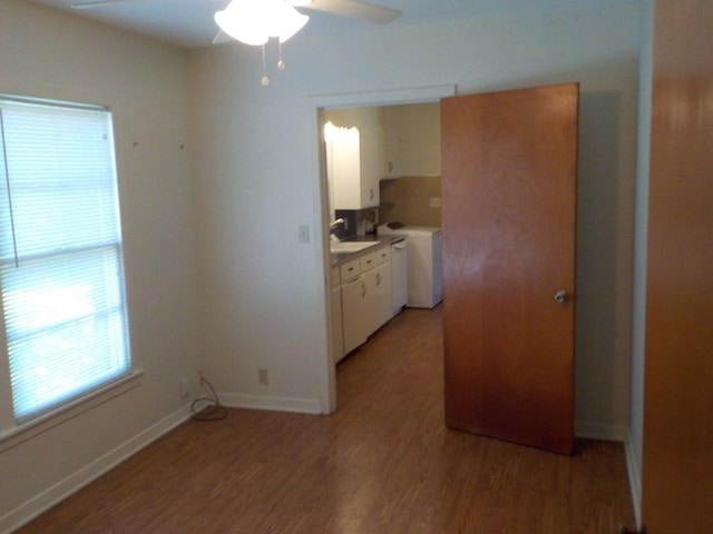 kitchen with white cabinets, light hardwood / wood-style flooring, ceiling fan, and sink