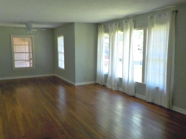 unfurnished room with ceiling fan and dark wood-type flooring