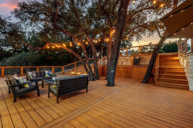 deck at dusk with outdoor lounge area