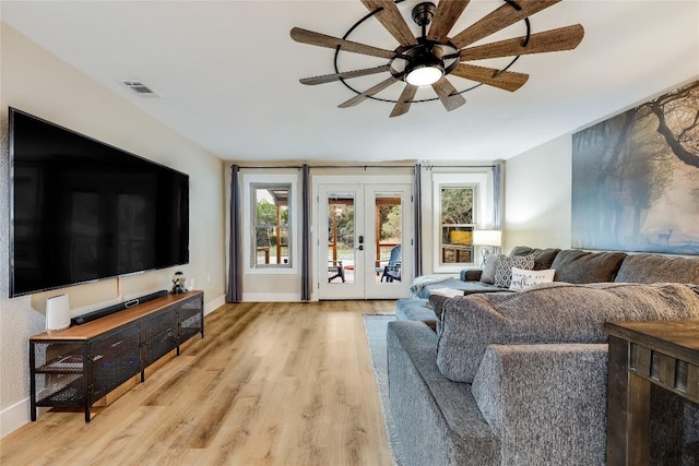 living room featuring light wood-type flooring and french doors