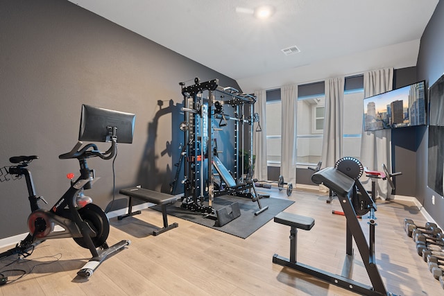 exercise area with light hardwood / wood-style floors