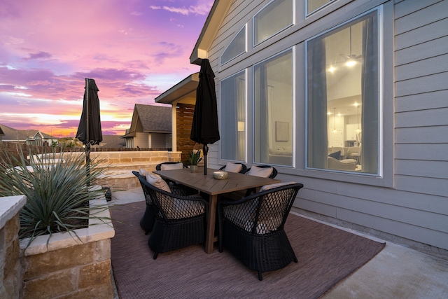 view of patio terrace at dusk