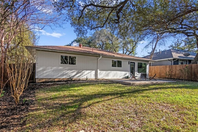 back of house featuring a yard and a patio