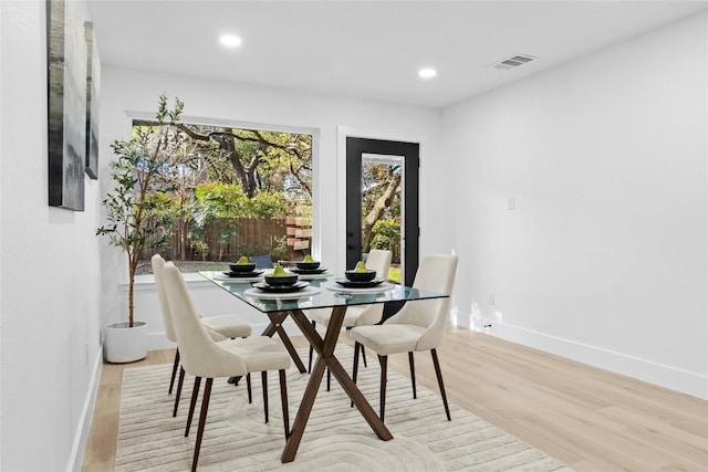 dining space featuring light wood-type flooring