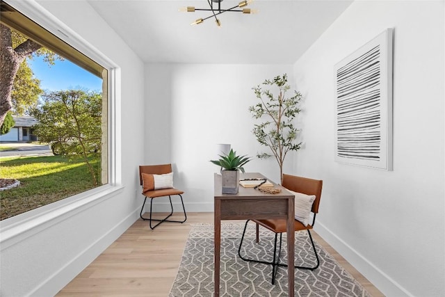 home office featuring a chandelier and light wood-type flooring