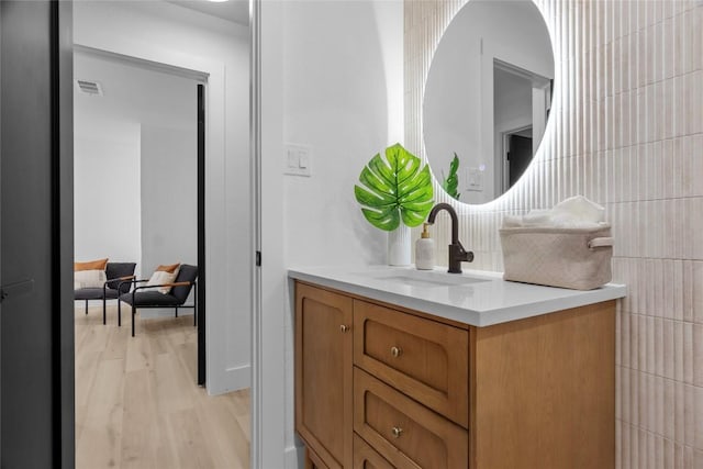 bathroom featuring hardwood / wood-style flooring and vanity